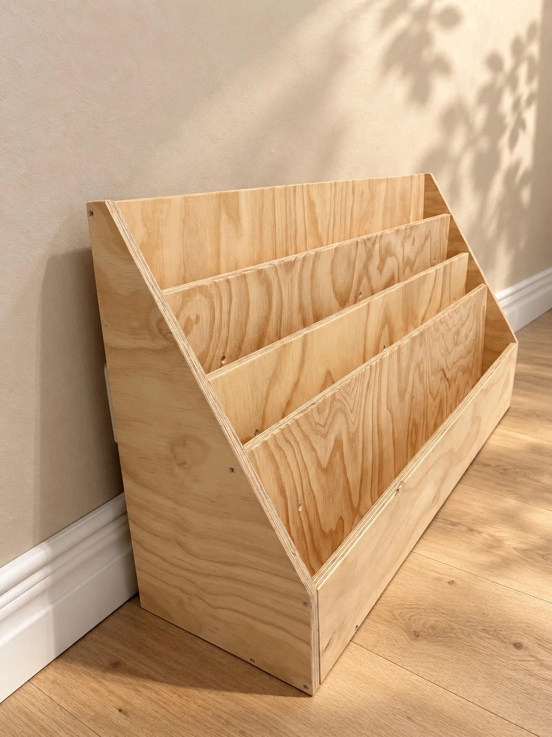 Empty natural plywood bookshelf showing its tiered storage compartments