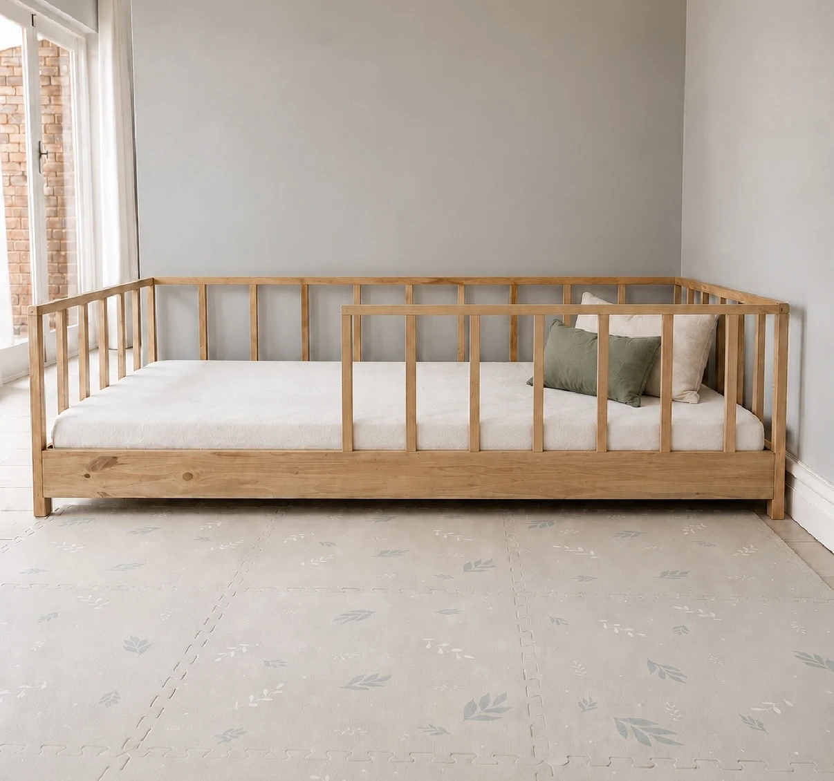 Natural wood Willow House floor bed with a white mattress and soft cushions